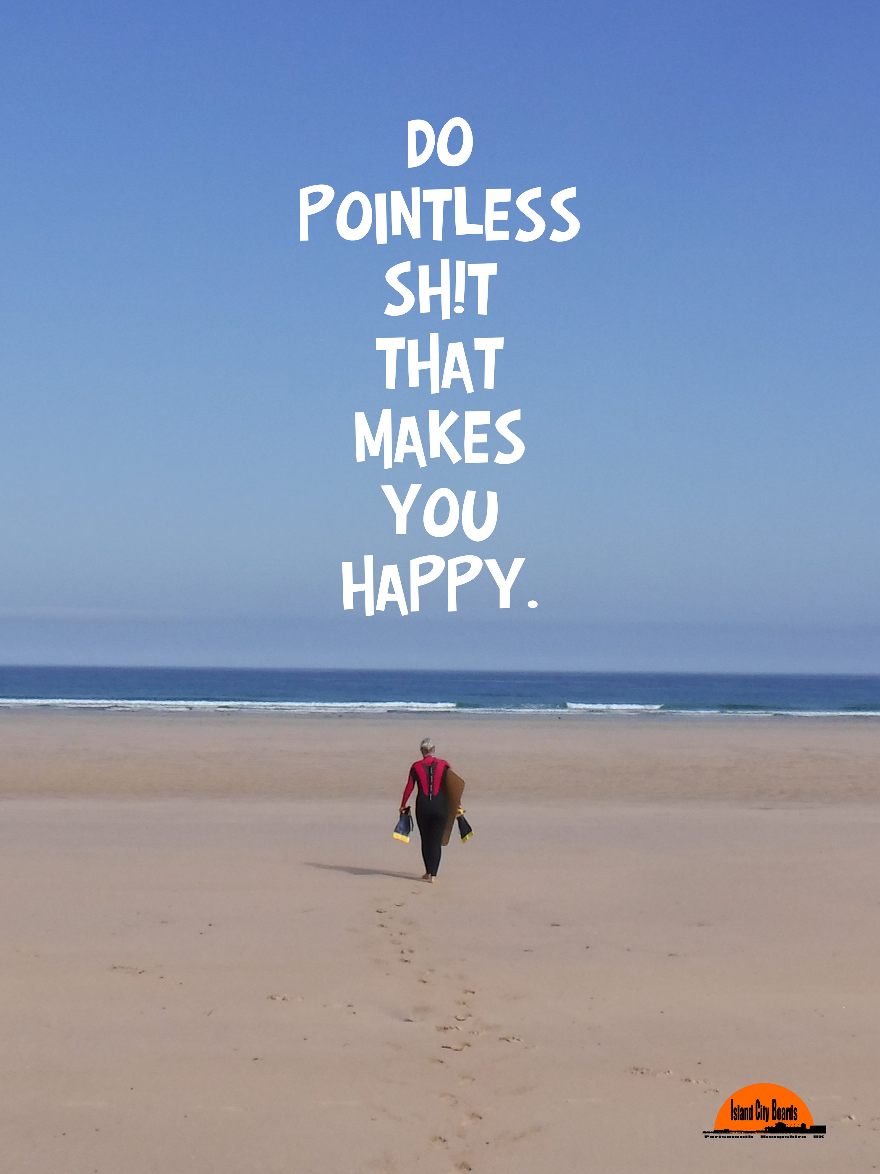 Person walking on the beach wearing a wetsuit, holding a bellyboard, with text overlay reading 'Do pointless shit that makes you happy.'